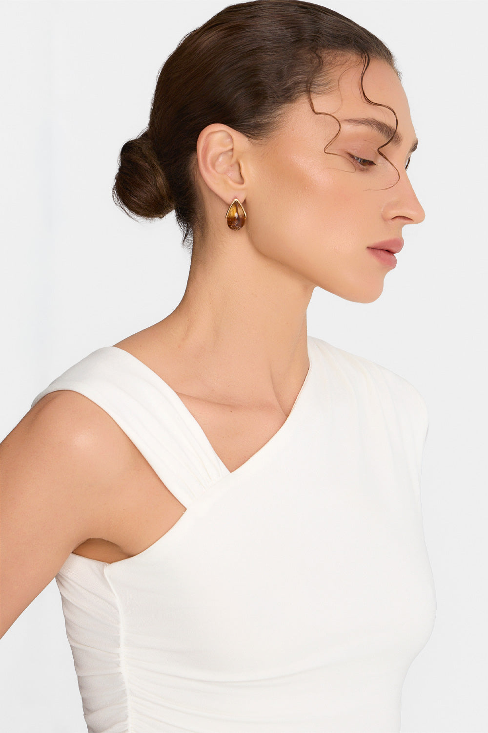 Women's asymmetrical top with draping and ruffles at the waist in